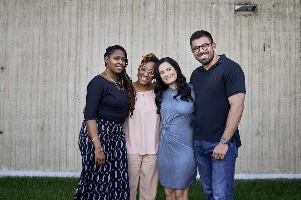 Four Friends Smiling and Embracing Outside
