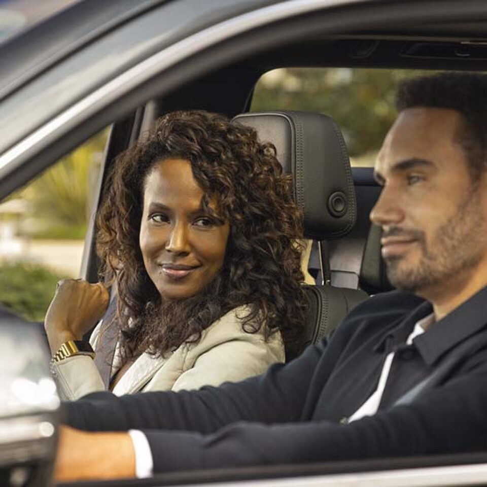 Man Driving and Woman Looking over at him Smiling