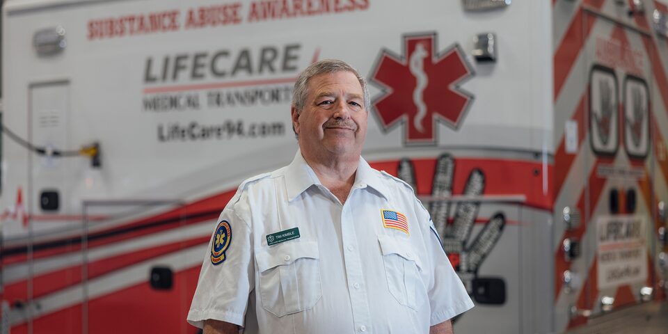 Timothy Kimble First Responder Standing Next to Ambulance