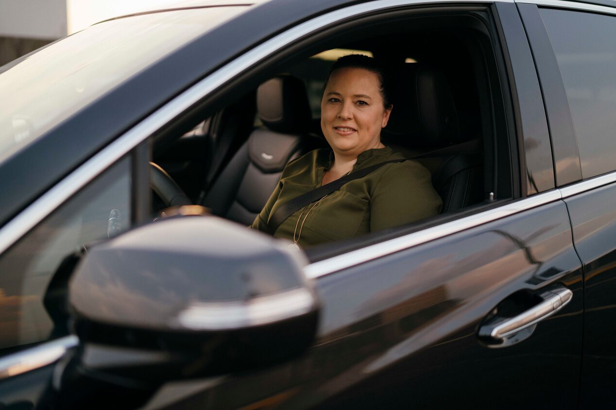 Women Sitting in Drivers Seat Smiling