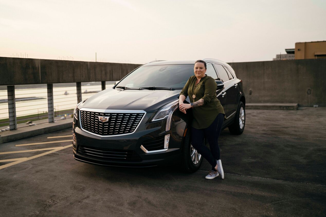Women Leaning onto Hood of GM Vehicle