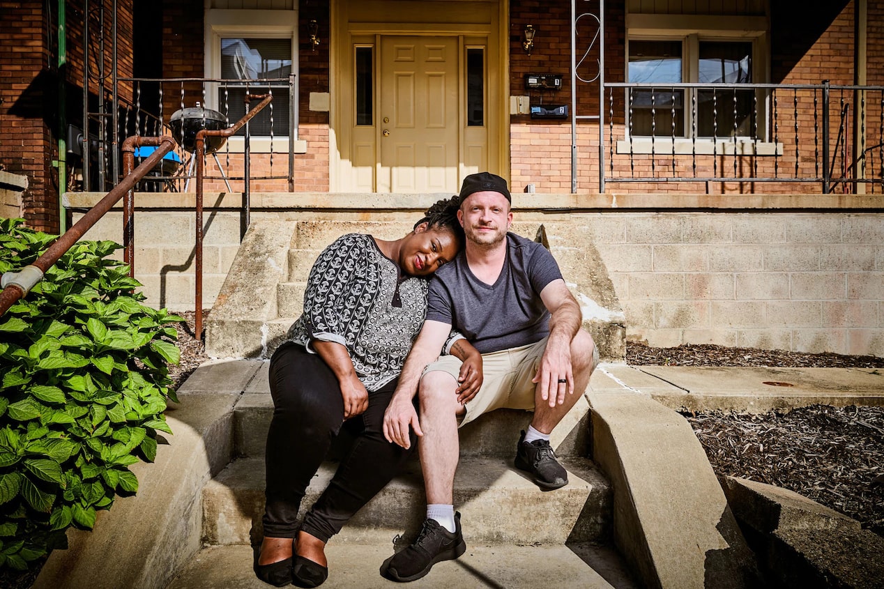 Couple Sitting Together on Front Door Step