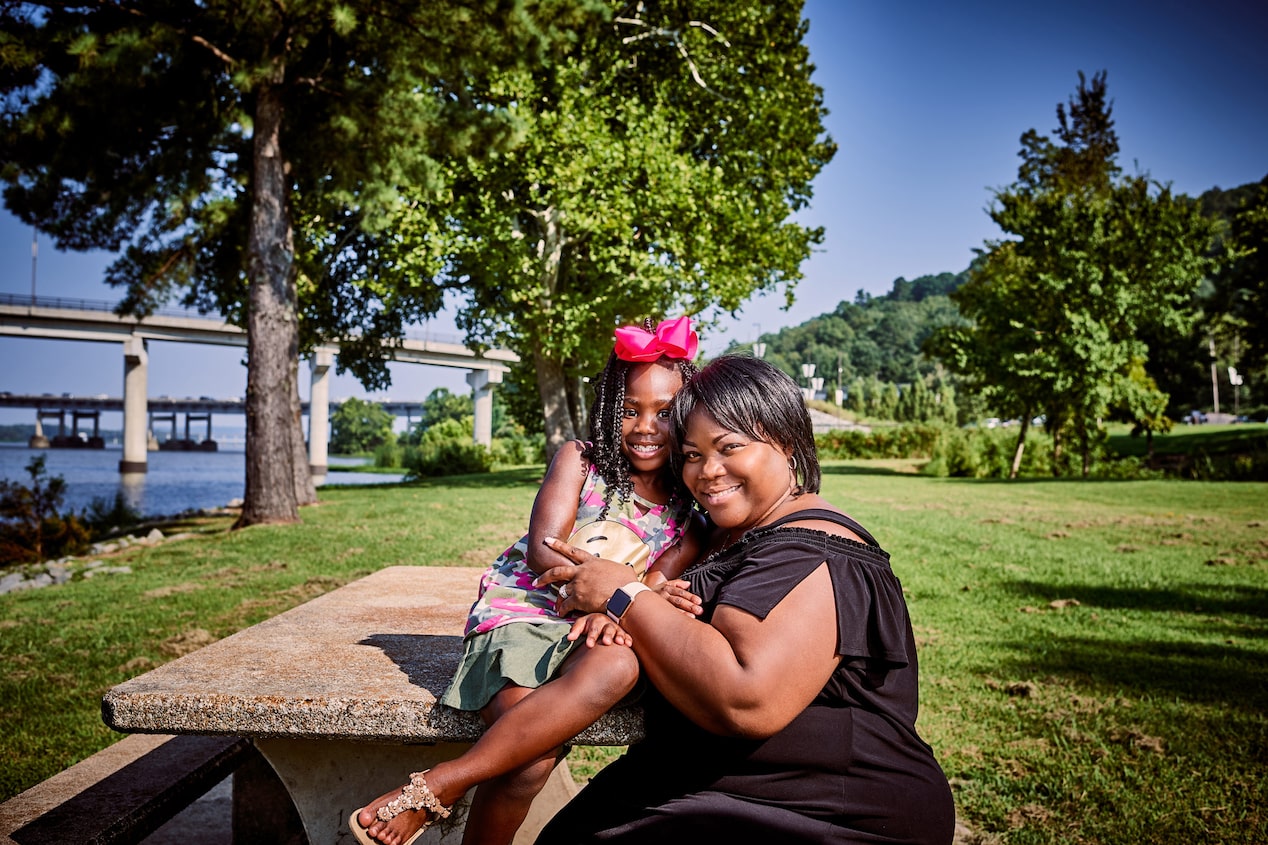 Mother and Daughter Sitting Together at Picnic Table
