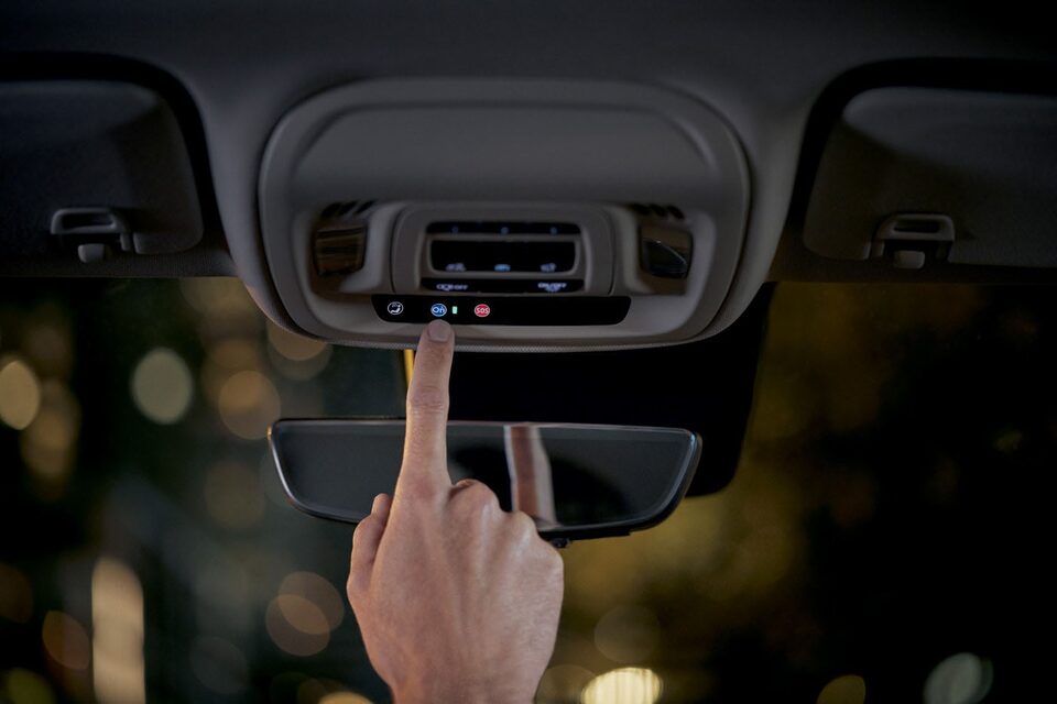 Close up of Driver Pressing the OnStar Button