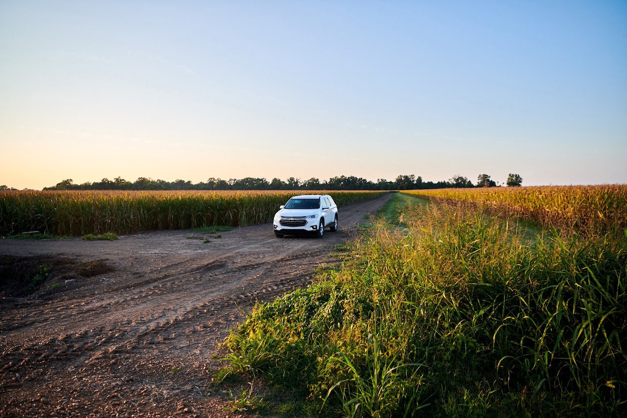 GM Vehicle Driving Down Country Road