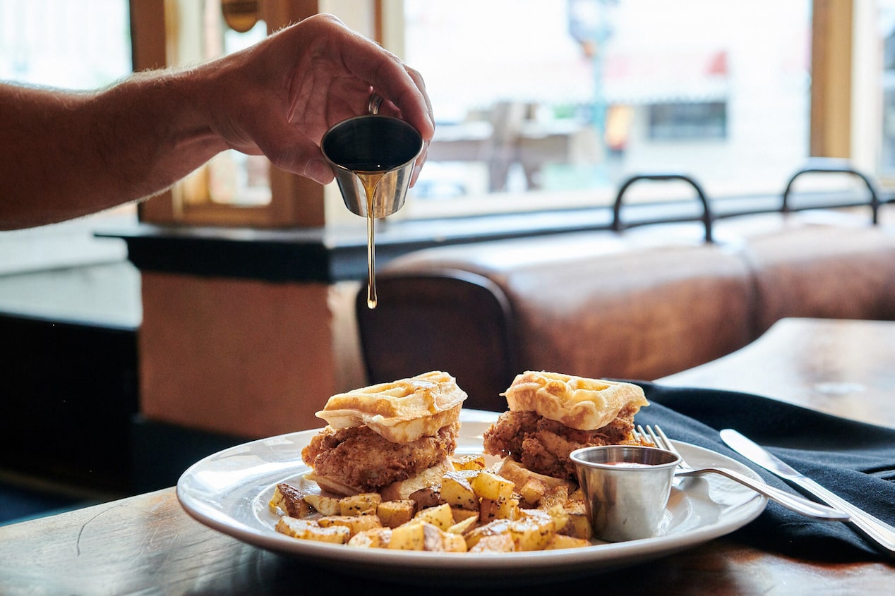 Customer Pouring Syrup onto Breakfast Plate