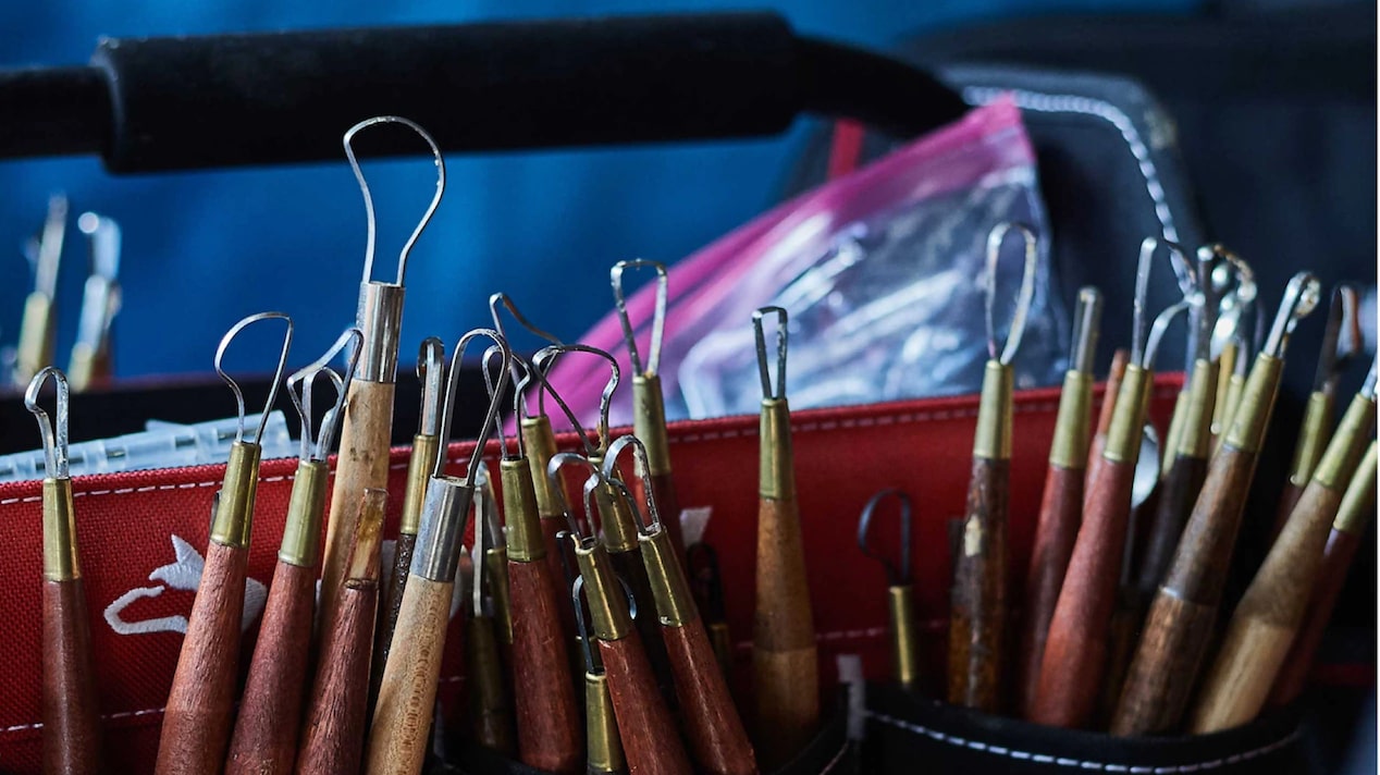 Close-Up of Metal Carving Tools Standing in Organizers