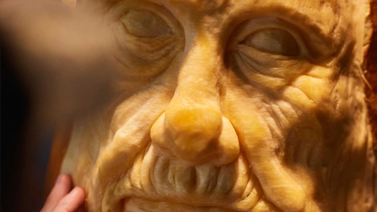 Close-Up of Old Wrinkly Face Being Carved With Precision