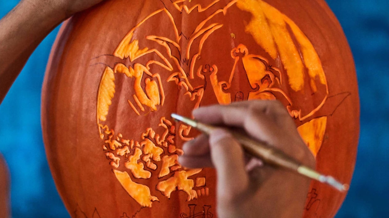 Intricate Pumpkin Carving Being Done With a Small Tool