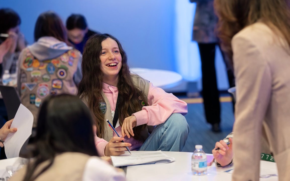 Mentors and students share a joyful moment during an OnStar Girl Scouts leadership event.