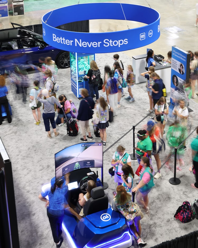 Attendees visit an interactive OnStar exhibition booth designed to inspire young women toward future STEAM technology leadership.