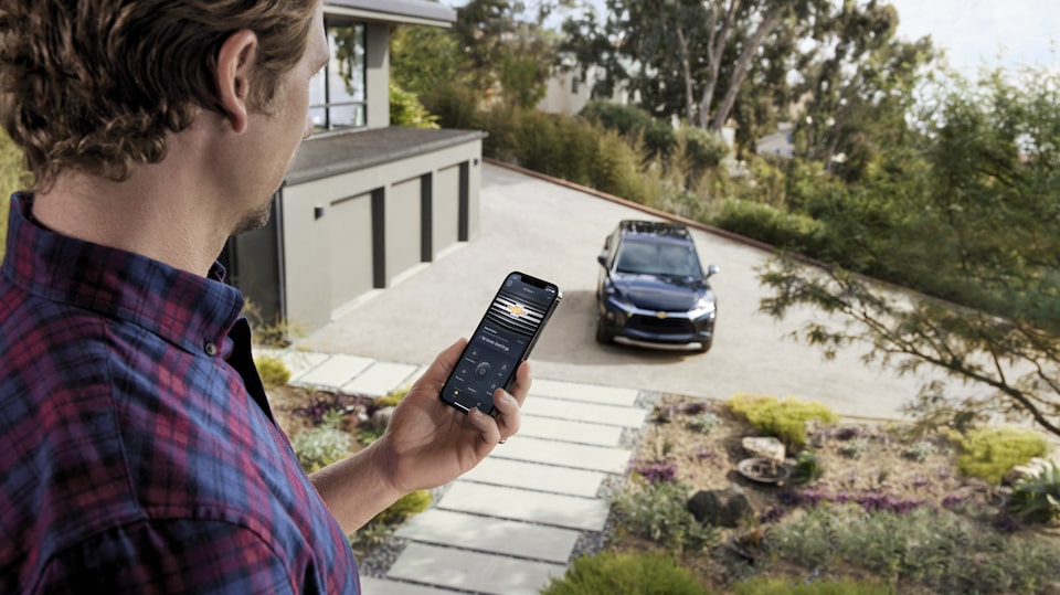 A Man Using the OnStar Guardian App on his Smartphone