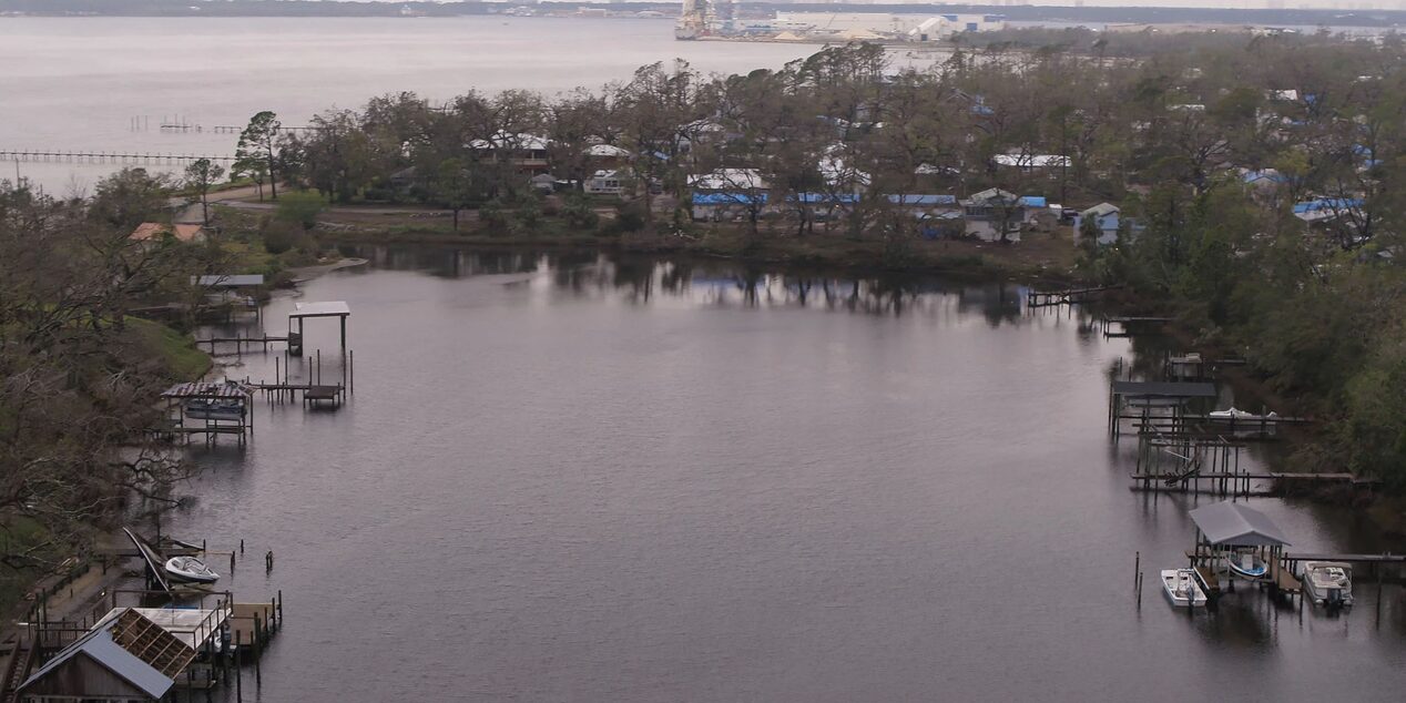 Small Bay of Water With Residential Homes Next to Ocean