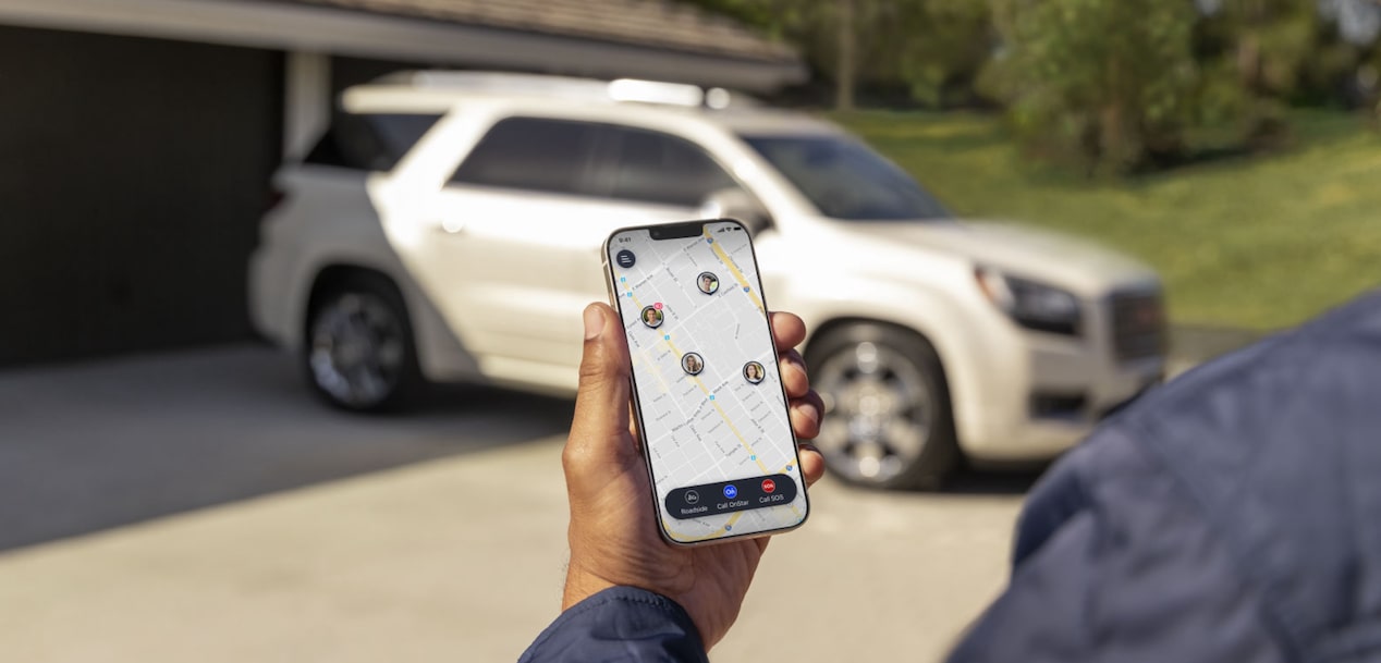 User Looking at the Guardian App With GMC SUV in the Background