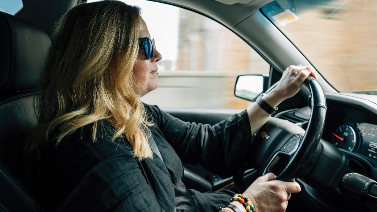 Woman Driving a Chevy SUV With Sunglasses on