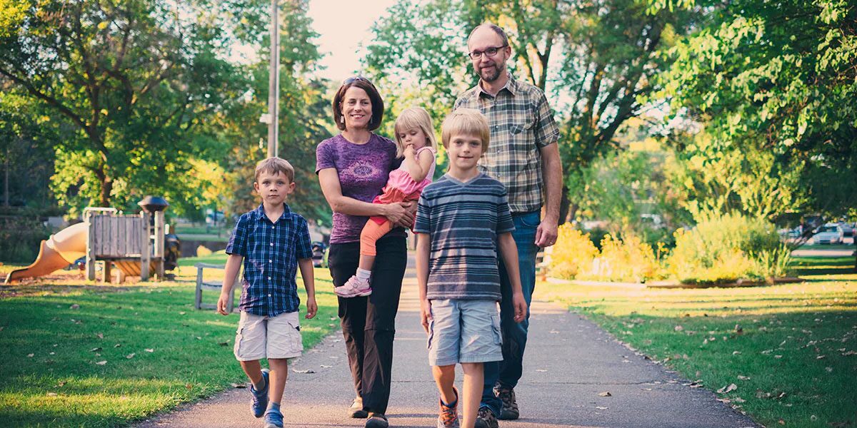 Family of Five Walking Through a Park