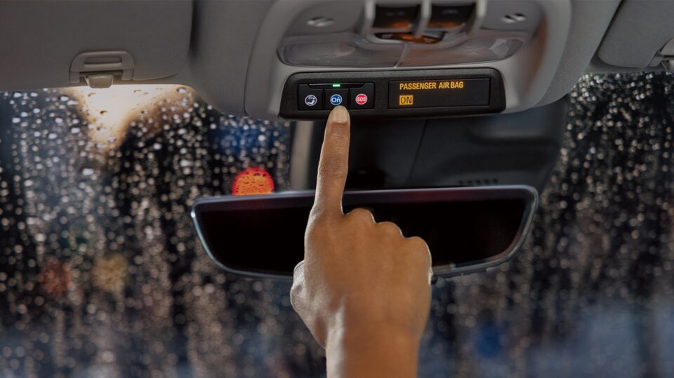 A Passenger Pressing the OnStar Button