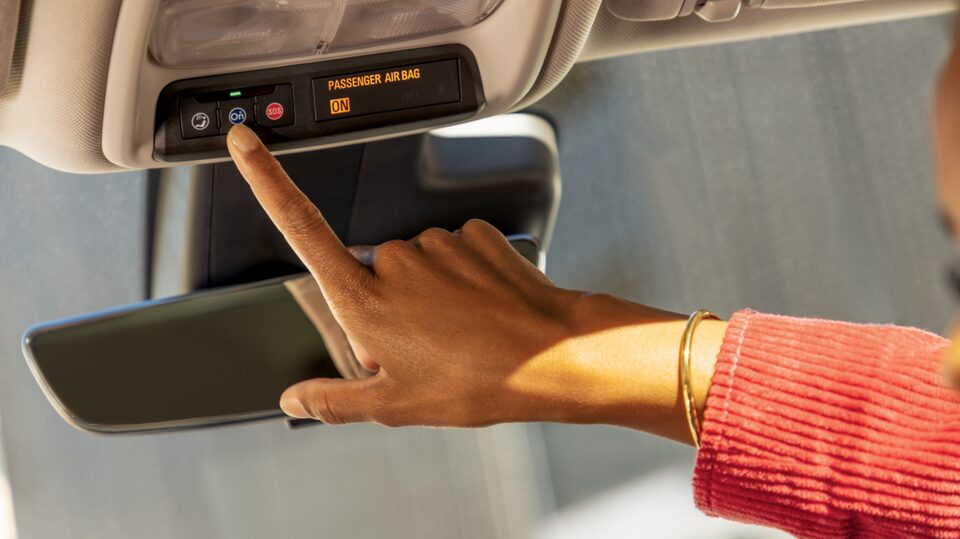 Close up of Passenger Pressing the OnStar Button
