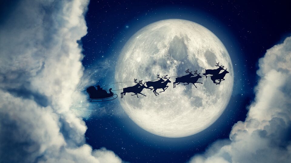Santa and His Reindeer Flying in Front of the Moon