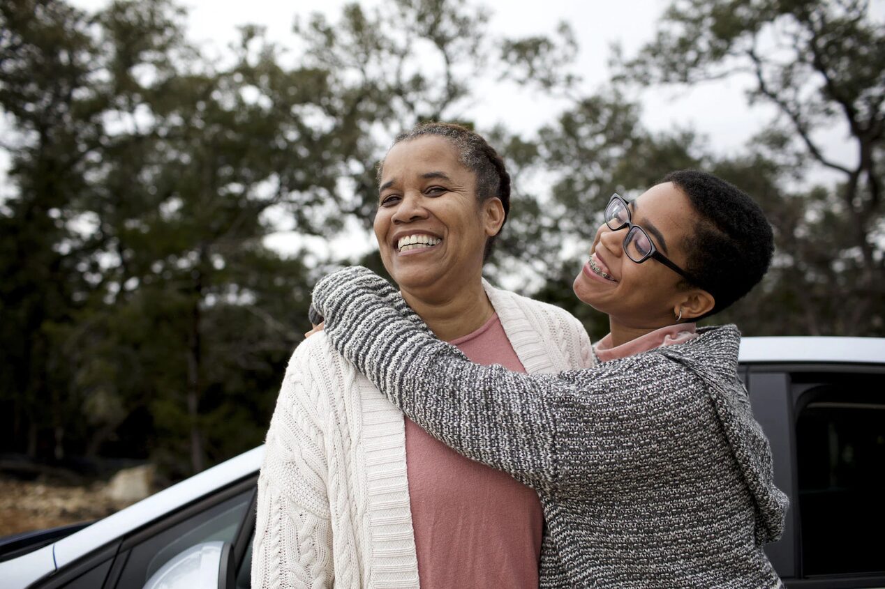 Two People Hugging and Smiling