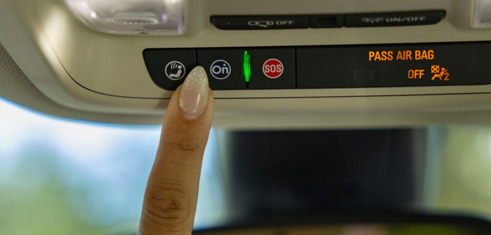 Close-up of someone pressing the nav panel on the vehicle