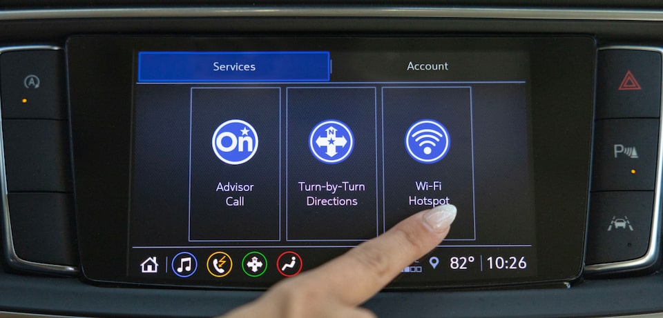 Image of a person pressing the WiFi hotspots button through OnStar