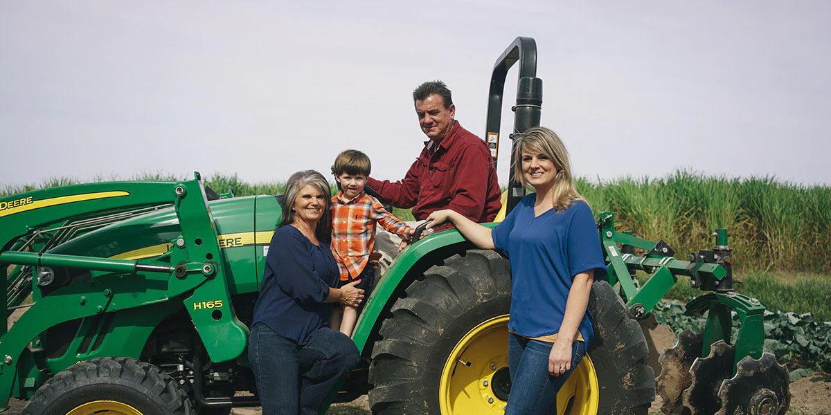 Family Gathered Together Around a Tractor