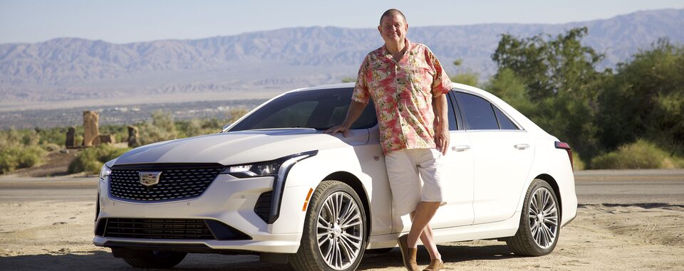 Rusty Austin standing next to his white 2021 Cadillac CT4