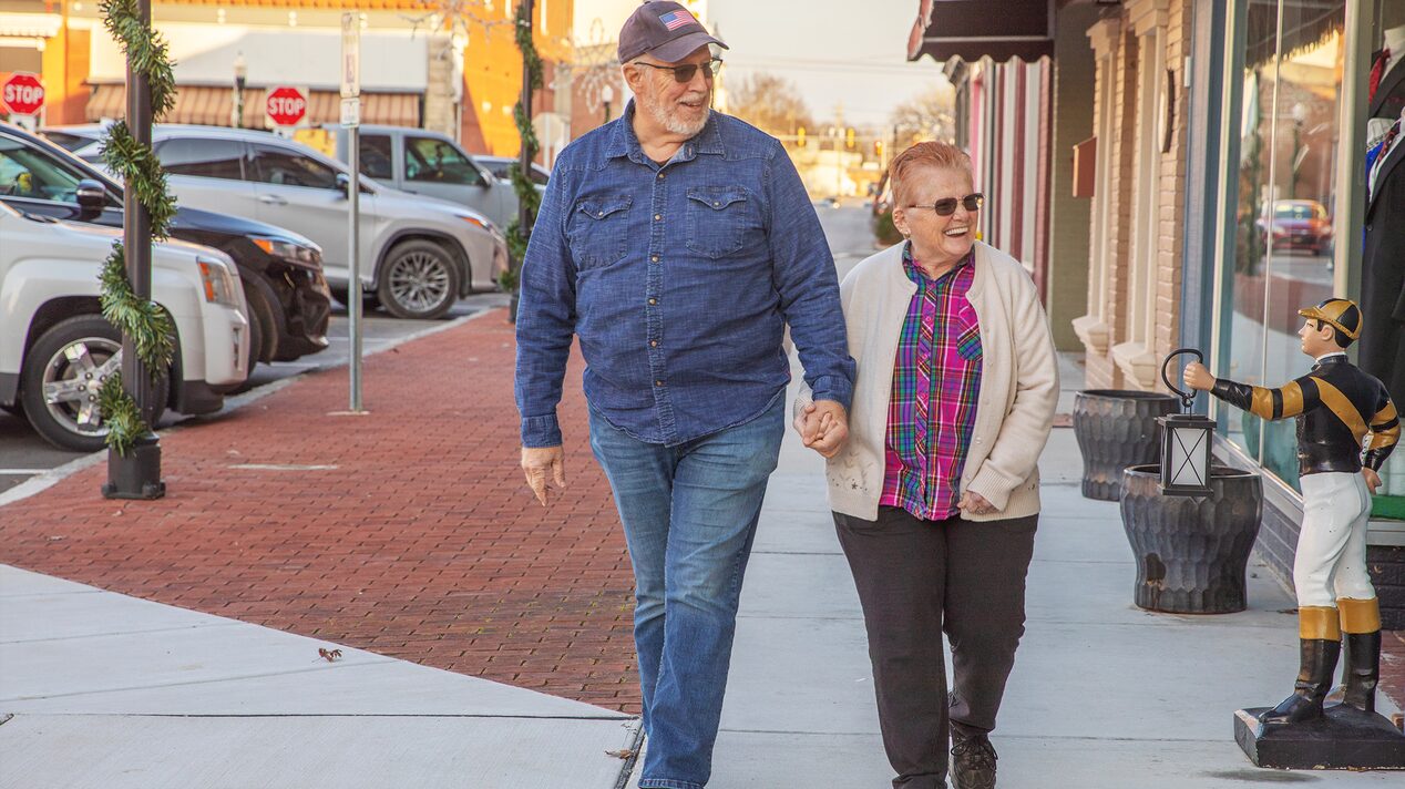 Glen and Roxanne Miller Walk Down the Street Together