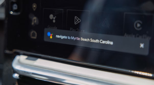 Close-up of the Google assistant listening to a command on a dashboard monitor