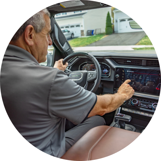 Marco in the driver's seat interacting with the dashboard of his GMC