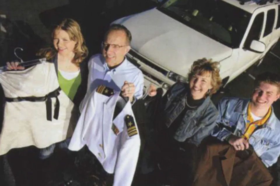 Two Couples Standing Together Infront of GM Vehicle
