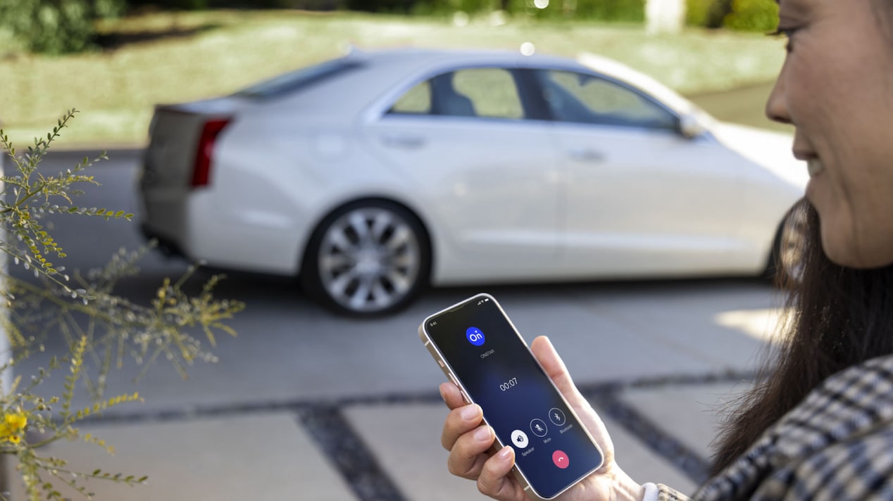 Woman Smiling & Making a Call From the OnStar Guardian App