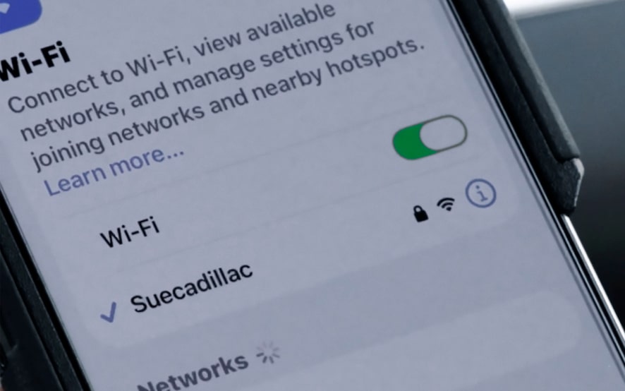 A smartphone screen displays Wi-Fi settings, showing "Suecadillac" as a connected network.