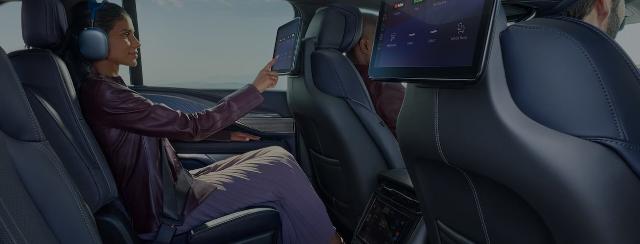 Close-up of Female Driver Pressing the OnStar Button 