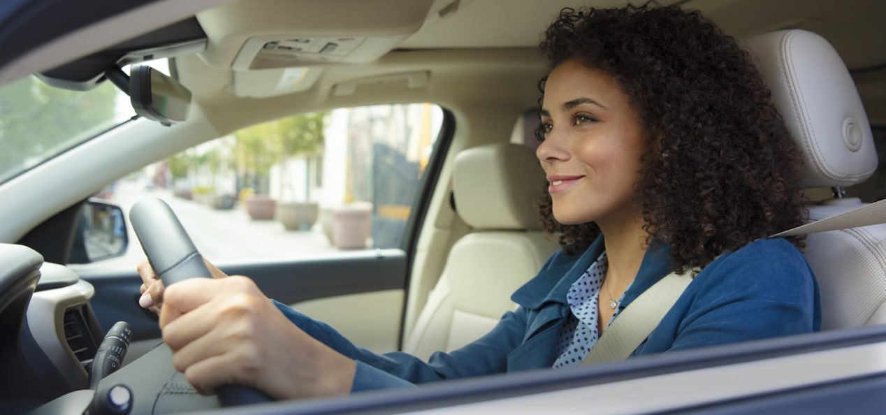 Woman Smiling While Driving 
