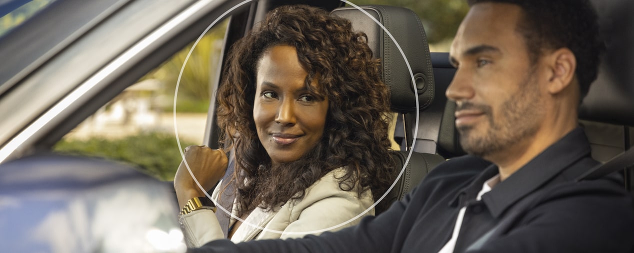Woman Glancing Over at Male Driver