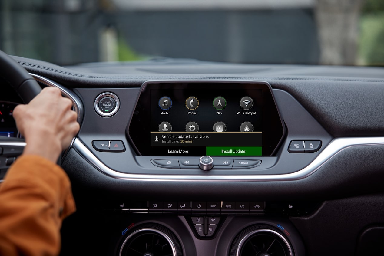 View of Center Console & Infotainment System With Person Driving