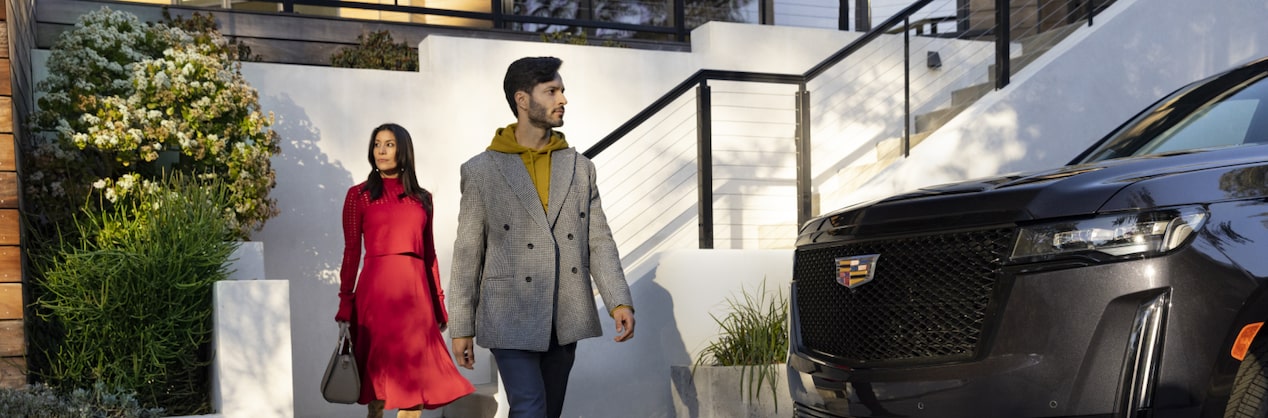 Man and Woman Walking out of their home to their car