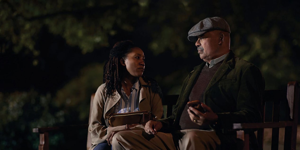Man and Woman Sitting on a Bench at Night