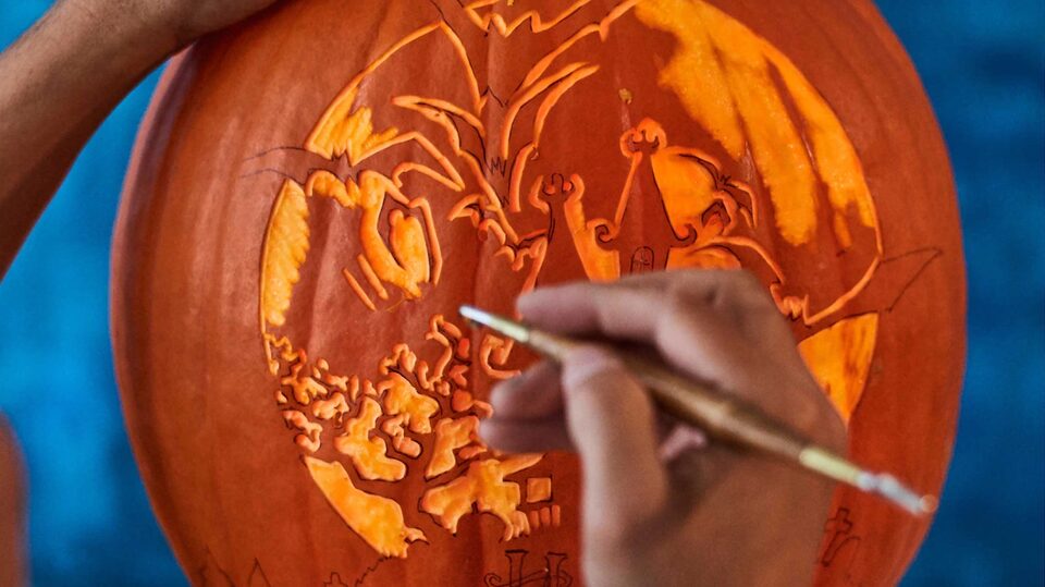 Intricate Pumpkin Carving Being Done With a Small Tool
