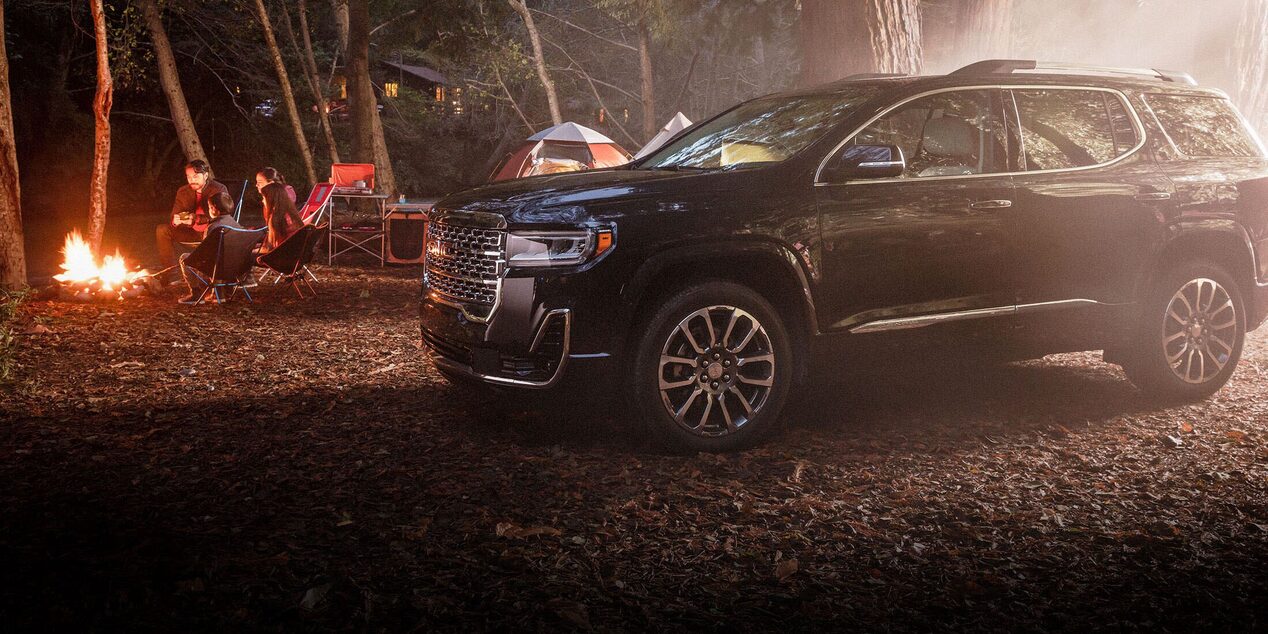 GM SUV Parked Next to a Cozy Campfire 