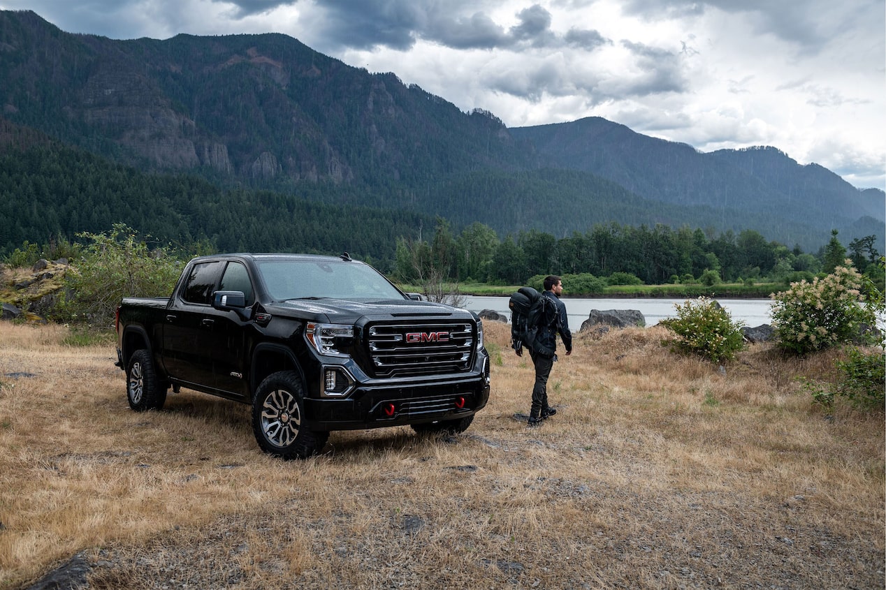 Hiker Next to GMC Truck & Beautiful Mountains