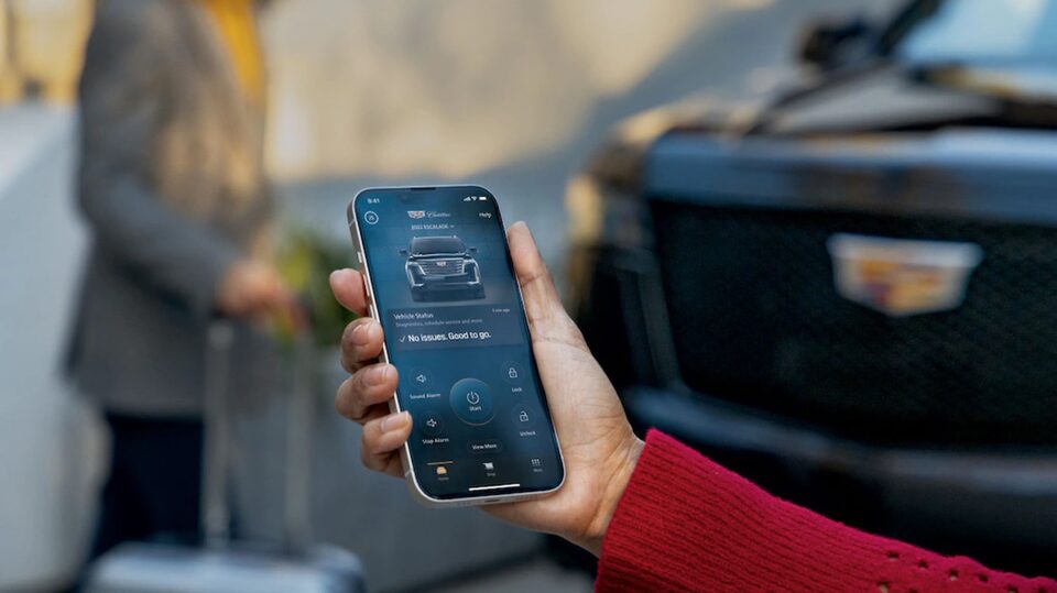 A Woman Checks the Charge Status of her Cadillac Using her Mobile App