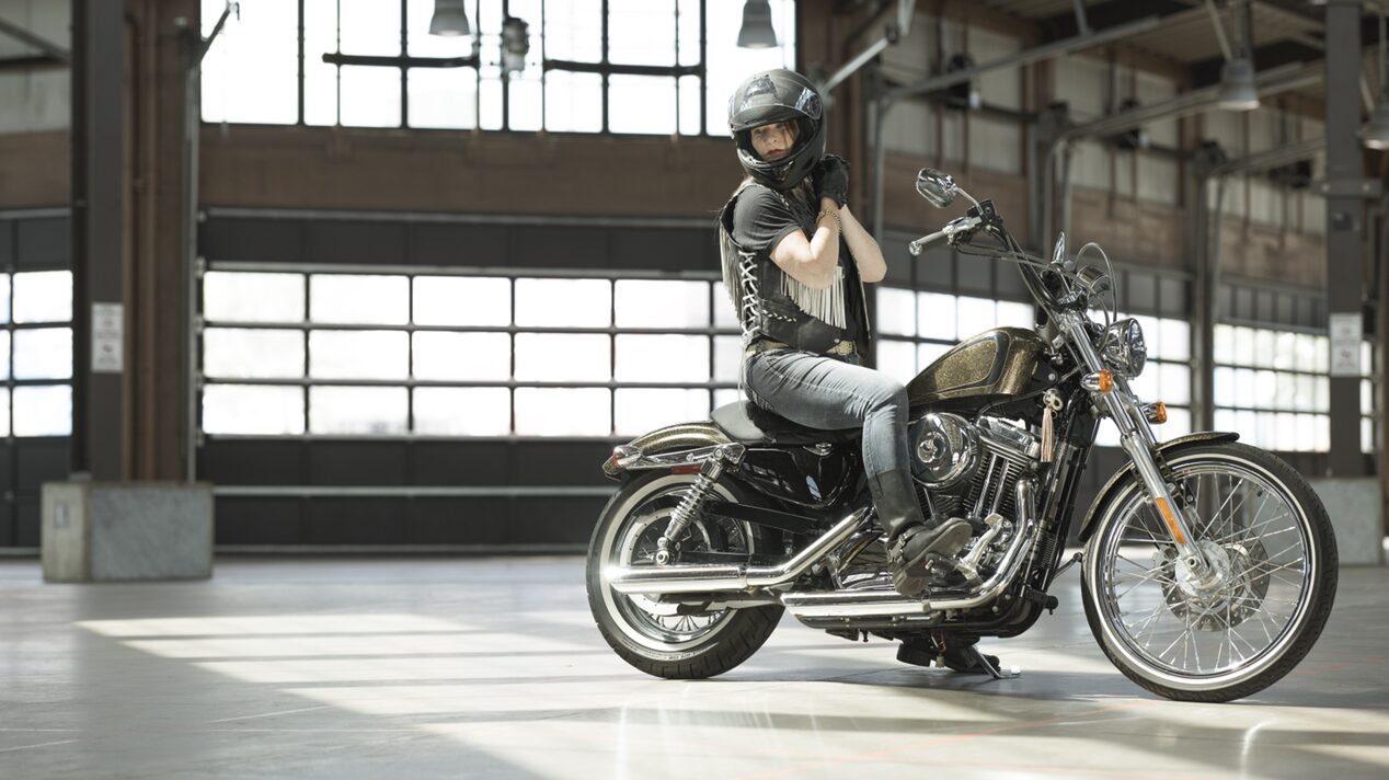Woman Adjusting her Helmet While Sitting on Her Motorcycle in Detroit’s Eastern Market