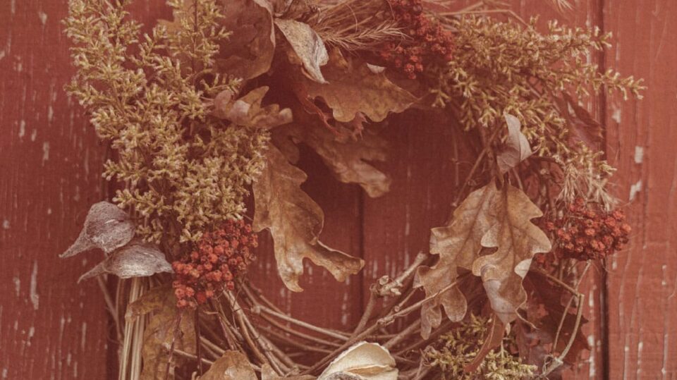 Homemade Wreath Hung Up on a Red Painted Wood Paneled Wall