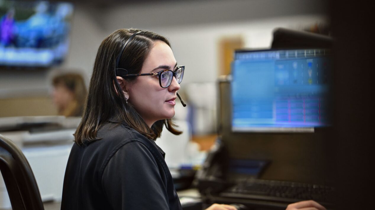 Side View of an OnStar Advisor Working on Her Desktop