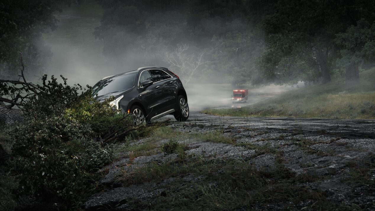 Car Crashed Down a Small Hill On the Side of a Dark Road