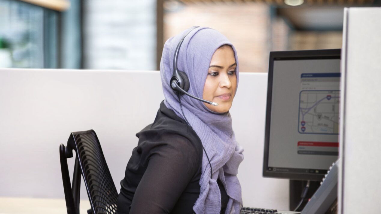 OnStar Advisor Wearing Headset and Working on the Computer