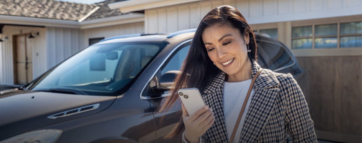 Woman Checking Her Smartphone While Walking Away From Vehicle